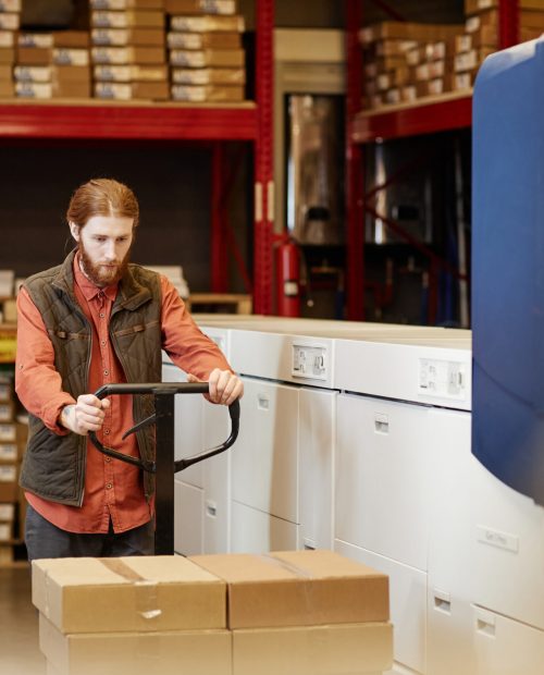 Worker Moving Boxes in Warehouse